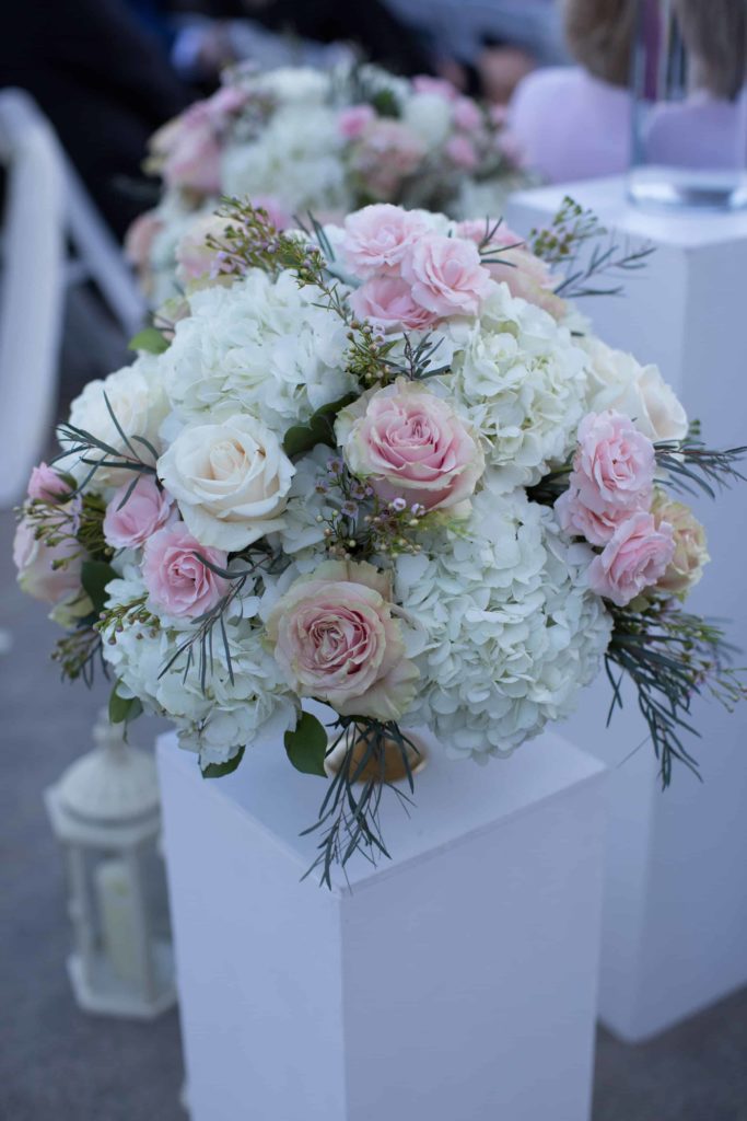 Detailed photo of floral design by Lynn's florals. Wedding ceremony by Orange County Beach Weddings.
