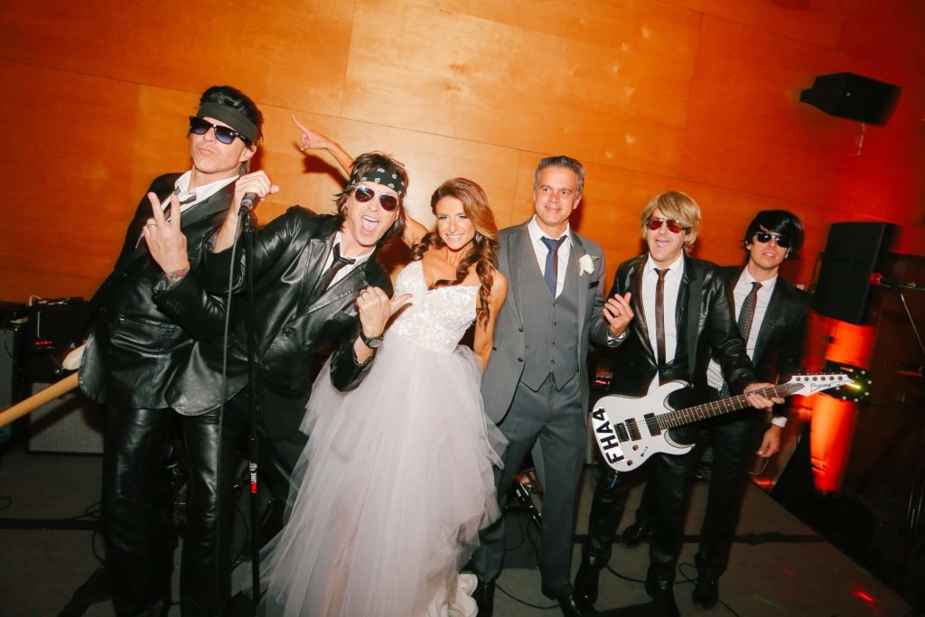 Dana takes a photo with the band Flashback Heart Attack at wedding by Orange County Beach Weddings