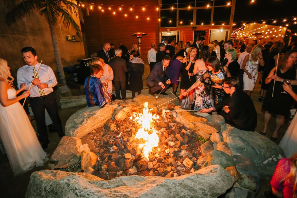 Guests making S'mores at Ocean Institute at wedding by Orange County Beach Weddings
