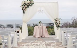 Champagne ceremony decor, wood arch, florals for ceremony arch