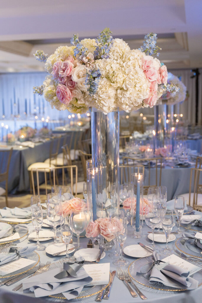 Tall floral arrangements with white, blush and blue flowers.