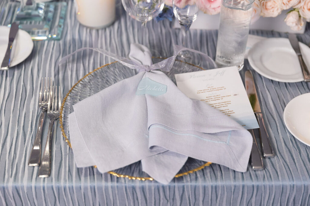 blue bbj linens, napkins and linens on a beautiful designed kings table.