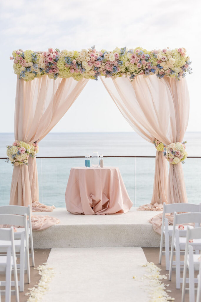 Wedding arch in blush with flowers in blush, white and light blue