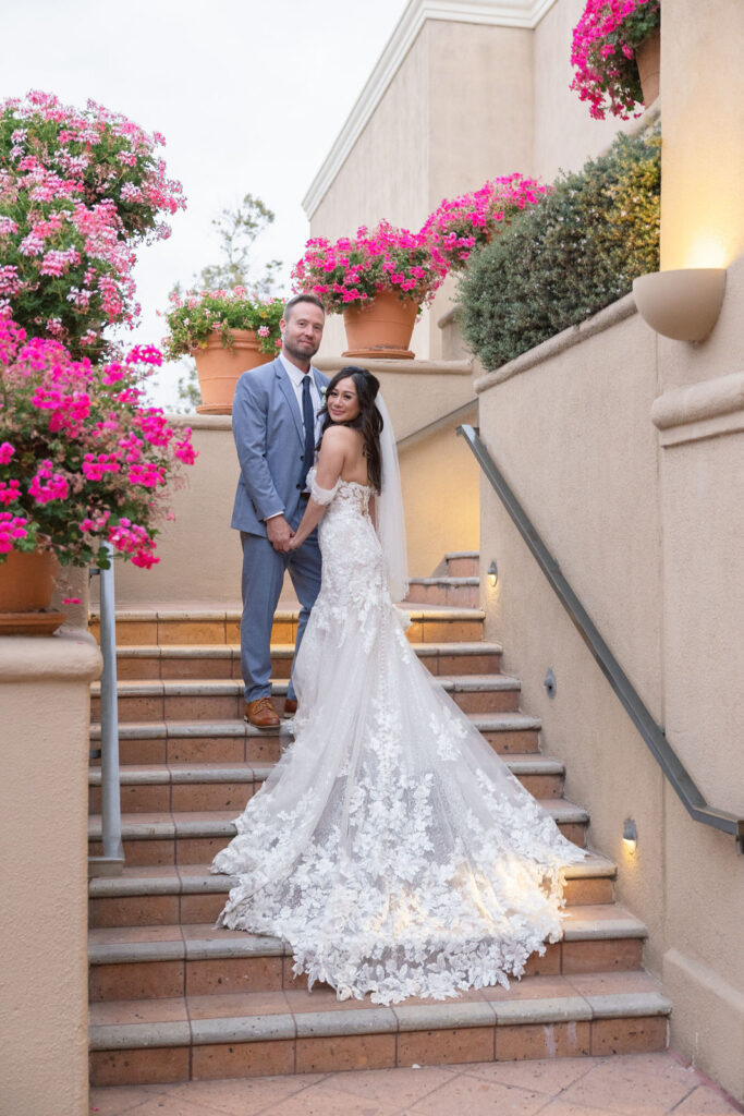 Bride & Groom on the stair steps of Surf & Sand Resort.