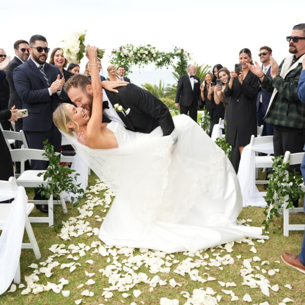 Groom dipping bride for wedding kiss